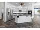 Gourmet kitchen featuring stainless steel appliances, white cabinets, and a center island at 35616 N 34Th Ln, Phoenix, AZ 85086