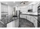 Modern kitchen with white cabinets, a black marble island, and stainless steel appliances at 35616 N 34Th Ln, Phoenix, AZ 85086