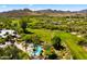 Aerial view of resort-style community with pool, golf course, lush landscaping and mountain backdrop at 38940 N 54Th St, Cave Creek, AZ 85331