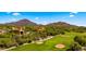 An aerial view of beautiful homes on a desert golf course, amid desert vegetation and mountains at 38940 N 54Th St, Cave Creek, AZ 85331