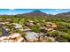 Stunning aerial view of desert home and community with mountain views and lush golf course at 38940 N 54Th St, Cave Creek, AZ 85331