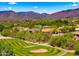 Luxurious homes line a lush golf course in a beautiful desert setting with mountains in the background at 38940 N 54Th St, Cave Creek, AZ 85331