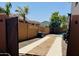 Well-maintained backyard with desert landscaping, showcasing a clear path to the pool and BBQ area at 41143 W Rio Bravo Dr, Maricopa, AZ 85138