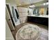 Bright, large bathroom with dual vanities, decorative rug, and ample counter space at 41143 W Rio Bravo Dr, Maricopa, AZ 85138