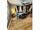 Dining room showcases modern table set, gray rug, decorative light fixture, and staircase at 41143 W Rio Bravo Dr, Maricopa, AZ 85138