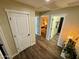 Hallway with wood look floors and multiple doorways at 41143 W Rio Bravo Dr, Maricopa, AZ 85138