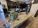 The kitchen features stainless appliances, stone countertops, dark cabinets, and recessed lighting at 41143 W Rio Bravo Dr, Maricopa, AZ 85138