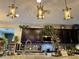 Bright kitchen displaying stone countertops, dark cabinets, recessed lighting, and decorative hanging fixtures at 41143 W Rio Bravo Dr, Maricopa, AZ 85138