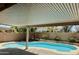 Inviting backyard pool area featuring a covered patio, perfect for outdoor relaxation and entertaining at 41143 W Rio Bravo Dr, Maricopa, AZ 85138