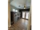 Well-lit sun room featuring tiled floors, a fan, glass patio doors, and animal cages at 41143 W Rio Bravo Dr, Maricopa, AZ 85138