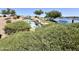 Beautiful community water feature with lush landscaping and a relaxing waterfall at 41143 W Rio Bravo Dr, Maricopa, AZ 85138