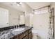 Bathroom featuring a dark marbled granite countertop, undermount sink, a large mirror, and a shower-tub combination at 4346 E Prickly Pear Trl, Phoenix, AZ 85050