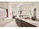 Elegant bathroom with double vanity, granite counters, soaking tub, and walk-in shower with glass enclosure at 4346 E Prickly Pear Trl, Phoenix, AZ 85050