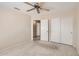 Carpeted bedroom with bi-fold door closet and an entry to an adjacent bathroom at 4346 E Prickly Pear Trl, Phoenix, AZ 85050