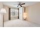 Bedroom featuring light neutral walls and carpet, a built-in wardrobe, and large window at 4346 E Prickly Pear Trl, Phoenix, AZ 85050