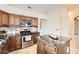 This lovely kitchen features an island, granite countertops, stainless appliances and beautiful cabinetry at 4346 E Prickly Pear Trl, Phoenix, AZ 85050
