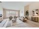 Inviting living room with plantation shutters, neutral paint, modern furnishings, and neutral carpet at 4346 E Prickly Pear Trl, Phoenix, AZ 85050