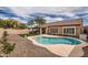 Backyard featuring a kidney-shaped pool, patio, artificial turf, desert landscaping, and a covered patio area at 4346 E Prickly Pear Trl, Phoenix, AZ 85050