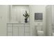 Modern bathroom with white cabinetry, a sink, and a plant at 4552 S 232Nd Dr, Buckeye, AZ 85326