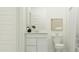 Modern bathroom with white cabinetry, a sink, and a plant at 4552 S 232Nd Dr, Buckeye, AZ 85326