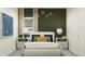 Beautiful bedroom featuring stylish decor, a modern light fixture, and neutral color palette at 4552 S 232Nd Dr, Buckeye, AZ 85326