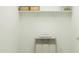 A clean laundry room with neutral tones and ample shelving for organized storage at 4552 S 232Nd Dr, Buckeye, AZ 85326