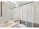 Functional bathroom with a spacious mirror, a vanity, a toilet with a patterned cover, and a shower curtain at 510 N Alma School Rd # 139, Mesa, AZ 85201