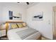 Bright bedroom featuring neutral walls, a ceiling fan, and a cozy bed with stylish bedding and modern decor at 510 N Alma School Rd # 139, Mesa, AZ 85201