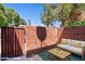 Enclosed patio with brick walls, a small seating area, and a wooden fence for privacy, ideal for outdoor living at 510 N Alma School Rd # 139, Mesa, AZ 85201