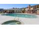 Community pool and spa area with fencing for safety and poolside seating at 510 N Alma School Rd # 139, Mesa, AZ 85201