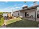 Landscaped backyard featuring a well-maintained lawn, covered patio, and storage shed at 510 W Marconi Ave, Phoenix, AZ 85023