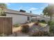 Landscaped backyard with colorful shrubbery, stone pathways, and well-maintained lawn at 510 W Marconi Ave, Phoenix, AZ 85023