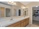 Bright bathroom featuring double sinks and large mirror reflecting the bathroom and closet at 510 W Marconi Ave, Phoenix, AZ 85023