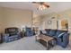 Spacious living room with vaulted ceiling, a sofa, armchairs, and views of the home's dining room at 510 W Marconi Ave, Phoenix, AZ 85023