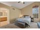 Serene main bedroom with large windows, a ceiling fan, and an ensuite bathroom at 510 W Marconi Ave, Phoenix, AZ 85023