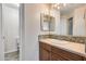 Single sink bathroom with granite countertops, light wood cabinets, and tile backsplash at 5729 S 21St Ter, Phoenix, AZ 85040