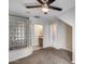 This carpeted bedroom features a glass block wall and open access to an en-suite bathroom at 5729 S 21St Ter, Phoenix, AZ 85040
