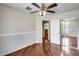 Bedroom with wood floors, a ceiling fan, a closet and neutral colored walls at 5729 S 21St Ter, Phoenix, AZ 85040