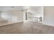 Bonus room featuring neutral carpet, a door to a balcony, and railing to the stairwell at 5729 S 21St Ter, Phoenix, AZ 85040
