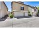 Exterior shot showcasing garage doors and facade of neutral color homes at 5729 S 21St Ter, Phoenix, AZ 85040