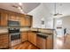A kitchen features granite countertops, stainless steel appliances, wooden cabinets and hard wood flooring at 5729 S 21St Ter, Phoenix, AZ 85040
