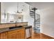 A kitchen features granite countertops, stainless steel appliances, wooden cabinets and a spiral staircase at 5729 S 21St Ter, Phoenix, AZ 85040