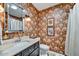 Bathroom with bold wallpaper, a framed mirror, a vanity, and a shower with a patterned curtain at 5738 N Scottsdale Rd, Scottsdale, AZ 85253
