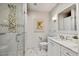 Well-lit bathroom featuring a glass-enclosed shower, a marble vanity, and neutral tones at 5738 N Scottsdale Rd, Scottsdale, AZ 85253