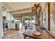 Bright dining area with tile floors, a unique chandelier, and access to the kitchen and patio at 5738 N Scottsdale Rd, Scottsdale, AZ 85253