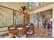 Spacious dining area adjacent to the living room, decorated with charming maps and lighting at 5738 N Scottsdale Rd, Scottsdale, AZ 85253