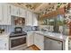 Well-lit kitchen with white cabinetry, stainless steel appliances, and tiled backsplash at 5738 N Scottsdale Rd, Scottsdale, AZ 85253