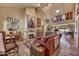 Comfortable living room features a fireplace, tile flooring, and access to the dining area at 5738 N Scottsdale Rd, Scottsdale, AZ 85253