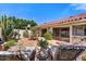 Wonderful brick-paved patio area with lounge chairs, dining table and access to house via sliding doors at 5738 N Scottsdale Rd, Scottsdale, AZ 85253
