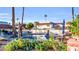 Inviting community pool with lush landscaping and lounge chairs, ideal for relaxation at 5738 N Scottsdale Rd, Scottsdale, AZ 85253